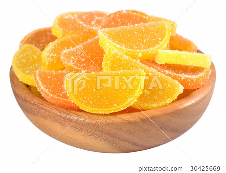 Orange and lemon candy slices in a wooden bowl Orange and lemon candy slices in a wooden bowl 30425669
