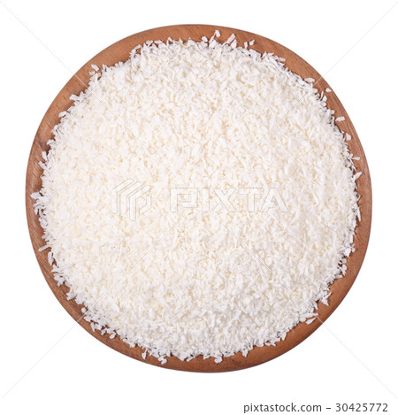 Shredded coconut in a wooden bowl on a white Shredded coconut in a wooden bowl on a white 30425772