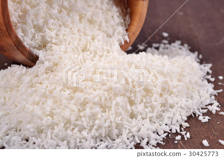 Shredded coconut in a wooden bowl Shredded coconut in a wooden bowl 30425773