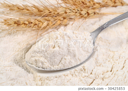 White flour in a spoon and ears of wheat White flour in a spoon and ears of wheat 30425853
