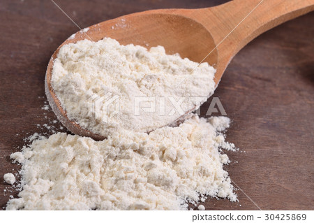 White flour in a wooden spoon 30425869