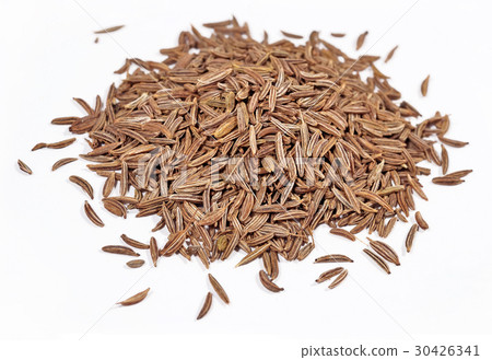 Heap of cumin seeds on a white 30426341