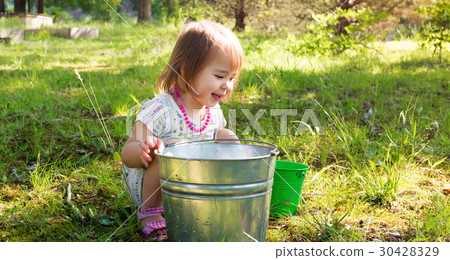 Happy toddler girl playing outside on a summer day 30428329