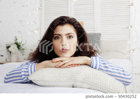 young pretty brunette woman in her bedroom sitting young pretty brunette woman in her bedroom sitting 30430252