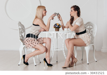 Two incredible girls are sitting at the table Two incredible girls are sitting at the table 30431521