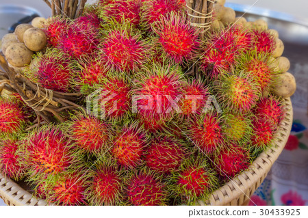 Red rambutan on brown wicker basket. Red rambutan on brown wicker basket. 30433925