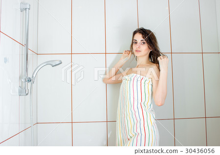 girl standing in a bathtub in a large towel and 30436056