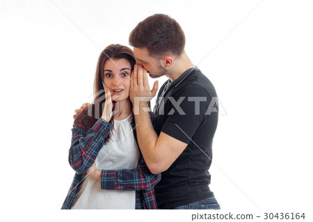 Guy something whispers in the ear of a young girl Guy something whispers in the ear of a young girl 30436164