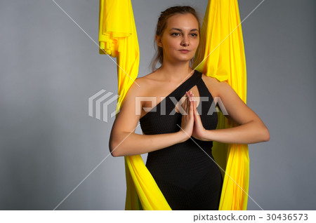 Blonde girl practicing aerial yoga, studio shot 30436573