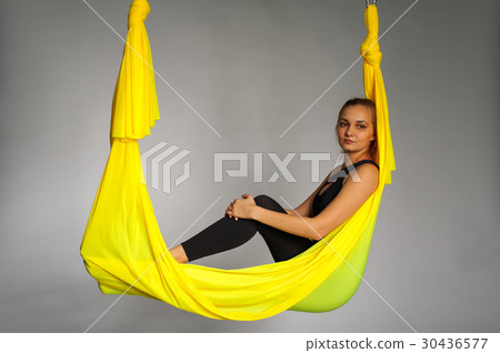 Young woman practicing aero yoga, studio shot. 30436577