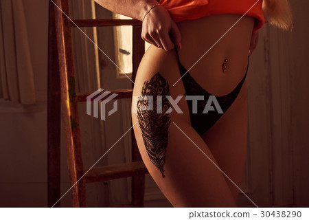 Sexy blonde woman with mehendi on her hip 30438290