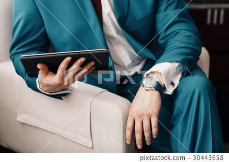 Businessman keep a digital tablet in hand whilst 30443658