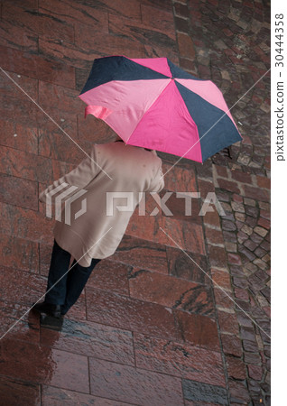 portrait of woman with umbrella on cobbles place  30444358