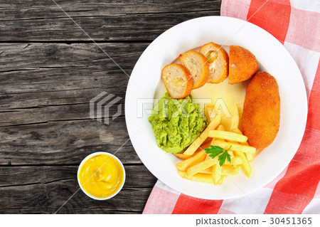 chicken rissoles, french fries, mashed pea chicken rissoles, french fries, mashed pea 30451365