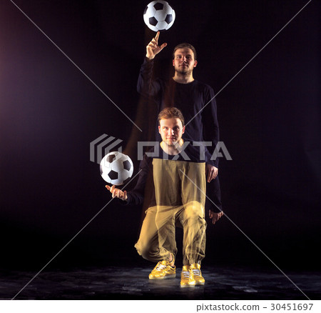 A portrait of a fan with ball on gray studio A portrait of a fan with ball on gray studio 30451697