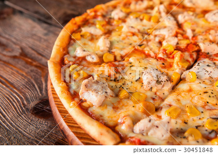 图库照片 pizza with chicken and corn on wood table close up