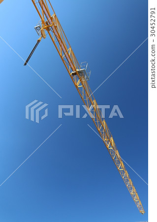 Construction site crane which shines in blue sky Construction site crane which shines in blue sky 30452791