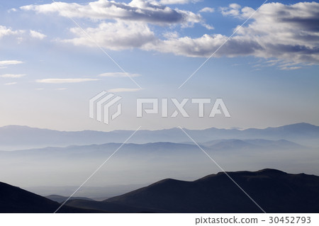 Silhouette of mountains in fog at early morning Silhouette of mountains in fog at early morning 30452793