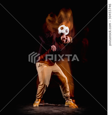 A portrait of a fan with ball on gray studio 30455746