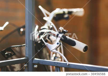 Steering wheel of city bicycle close up photo. 30456566