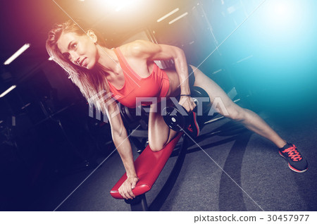 Beautiful sexy caucasian fitness girl training back in gym pumpi 30457977