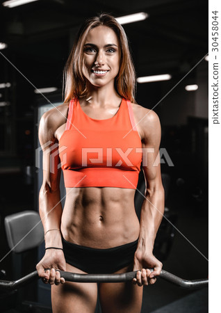 Caucasian pretty fitness girl on diet training pumping up muscle 30458044