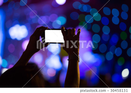 Hand with a smartphone records luxury party 30458131