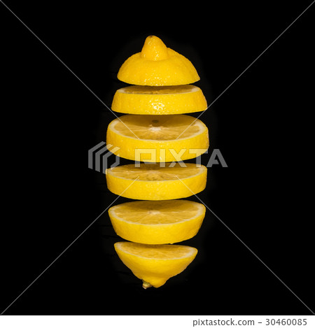 Flying lemon. Sliced lemon isolated on black background.  30460085
