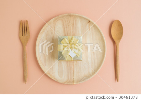 Top view of gold gift box on wooden plate 30461378