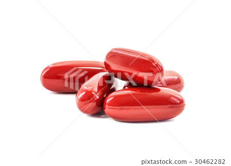 Red supplement capsules on white background 30462282