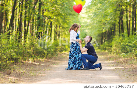 Caucasian pregnant woman and her husband outdoors Caucasian pregnant woman and her husband outdoors 30463757