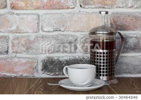 Teapot and a cup of tea on an old wooden table 30464846