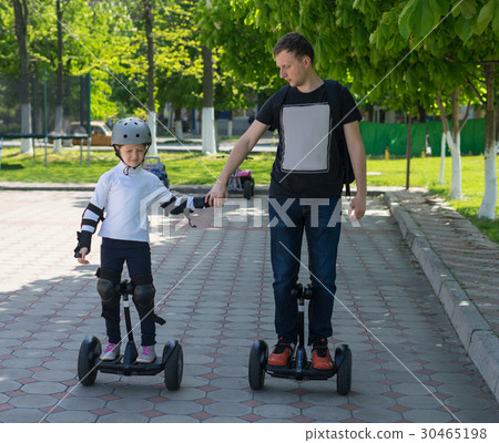 Young father teaching his daughter to ride Young father teaching his daughter to ride 30465198