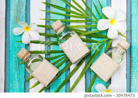 Massage oil set with palm leaf, flowers. Top view 30476473