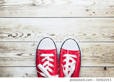 red gumshoes on floor 30482053