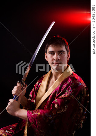 man holding samurai sword 30483093