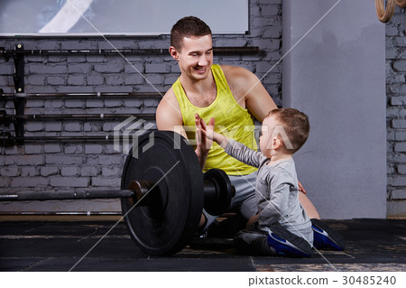 Young sporty father and little cute son sitting Young sporty father and little cute son sitting 30485240