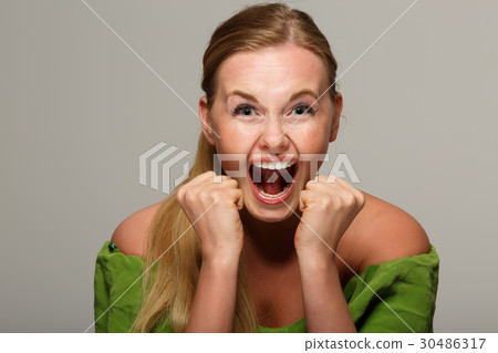 Screaming girl in green dress 30486317