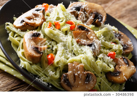 Spinach pasta with fried mushrooms and Parmesan 30486398