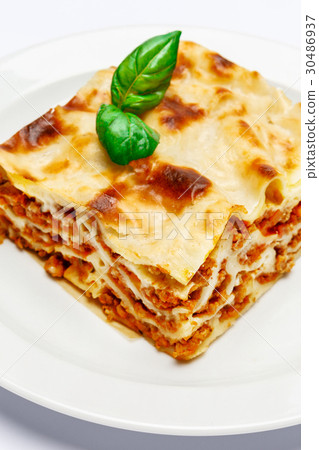 Portion of tasty lasagna isolated on white 30486937