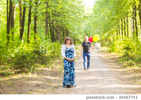Caucasian pregnant woman and her husband outdoors 30487741