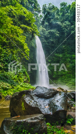 Amazing Nungnung waterfall, Big stone in front Amazing Nungnung waterfall, Big stone in front 30488317
