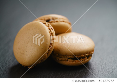 caramel brown macarons on slate background 30488972