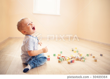 two years old child sitting on the floor with two years old child sitting on the floor with 30489364
