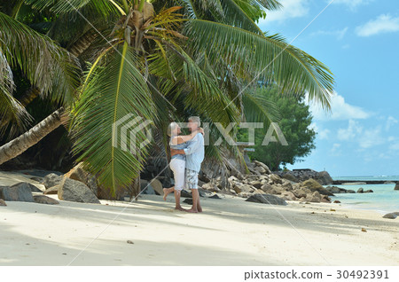 Elderly couple rest at tropical resort Elderly couple rest at tropical resort 30492391