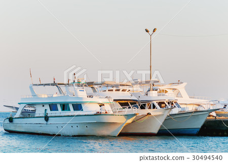 Many yachts moored to the pier. Hurgada, Egypt. Many yachts moored to the pier. Hurgada, Egypt. 30494540
