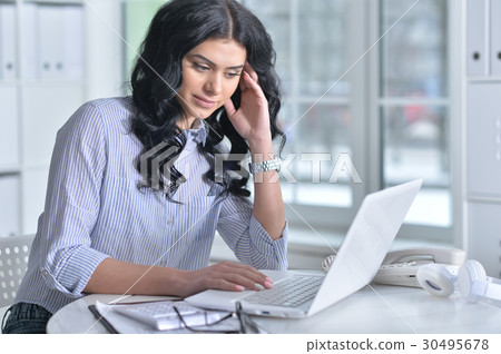 Business woman sitting at table Business woman sitting at table 30495678