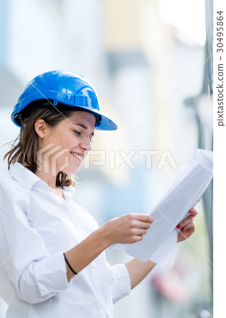 Female architect wearing blue helmet 30495864