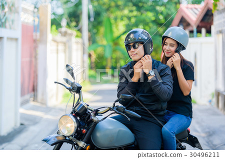 Young asian people is wearing helmet on motocycle. Young asian people is wearing helmet on motocycle. 30496211