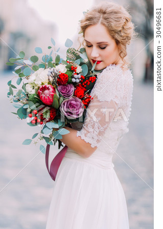 Beautiful bride softly holds wer vintage wedding 30496681